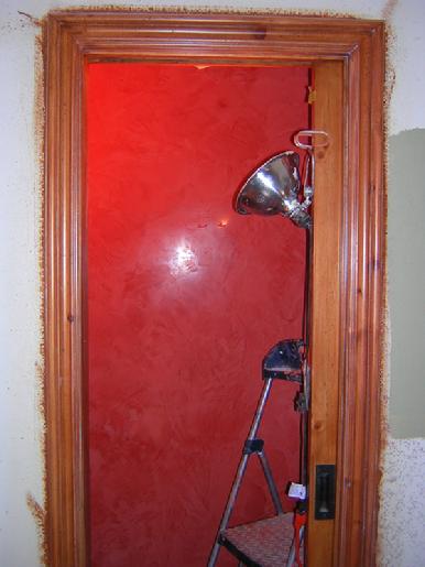 Venetian plaster in a bathroom with stained pine door